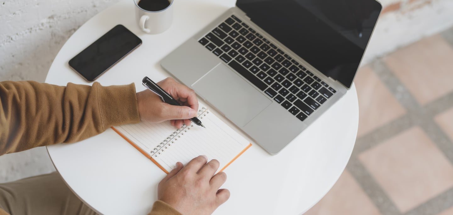 Person Writing on White Paper